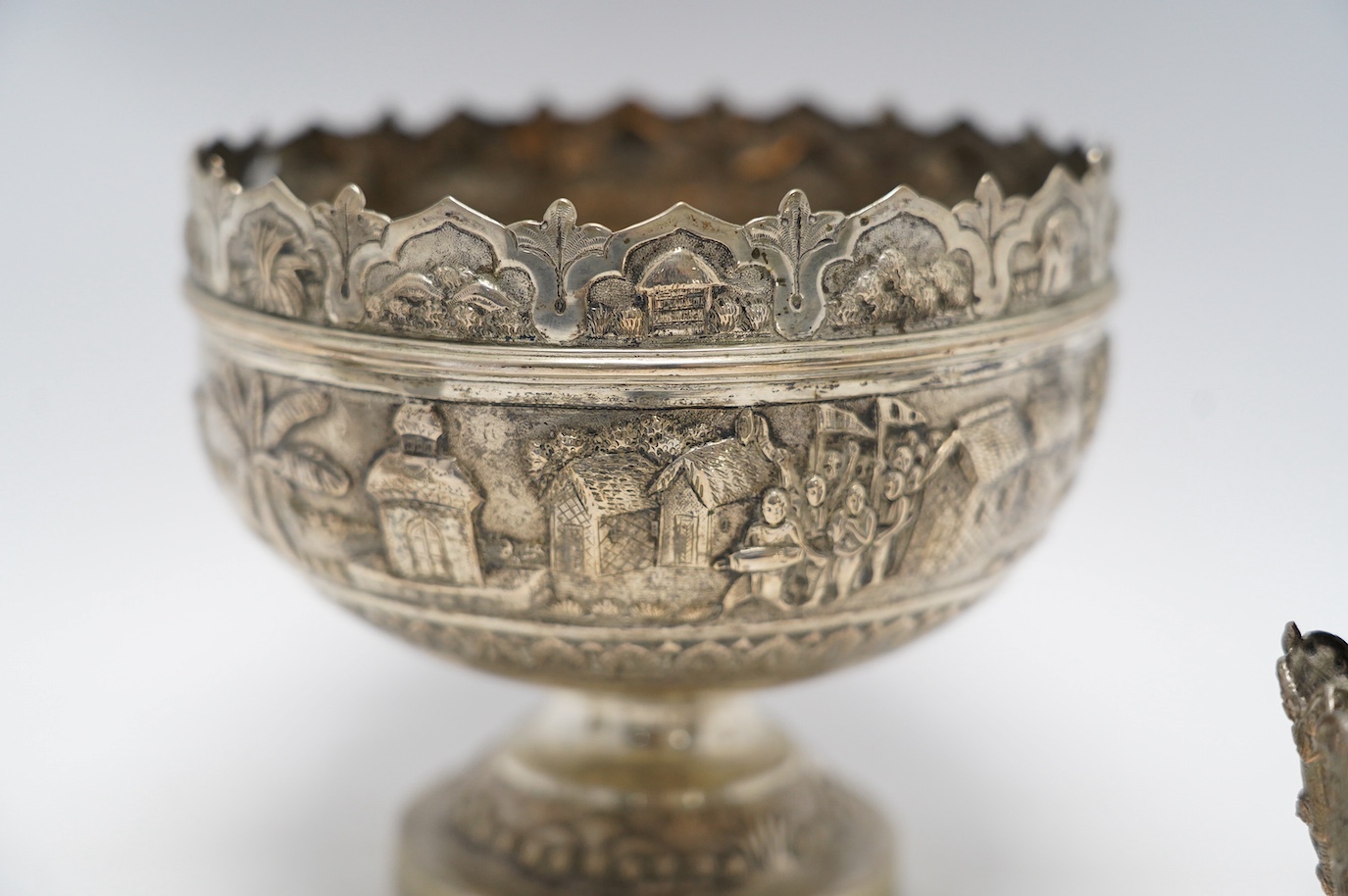 An Indian repousse white metal pedestal bowl, diameter 15.5cm (a.f.), a similar mug, small vase, condiment and small beaker. Condition - poor to fair